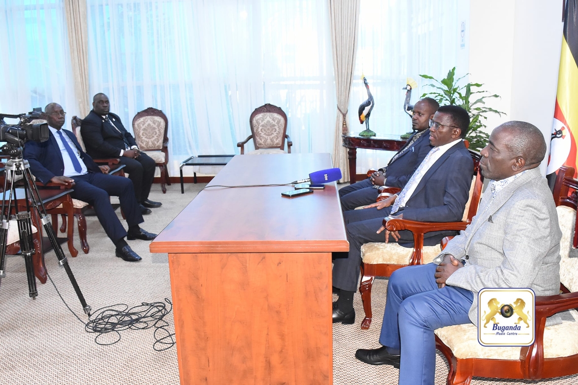 The Katikkiro addressing the press after arriving at Entebbe International Airport, alongside the ministers who accompanied him The Katikkiro addressing the press after arriving at Entebbe International Airport, alongside the ministers who accompanied him